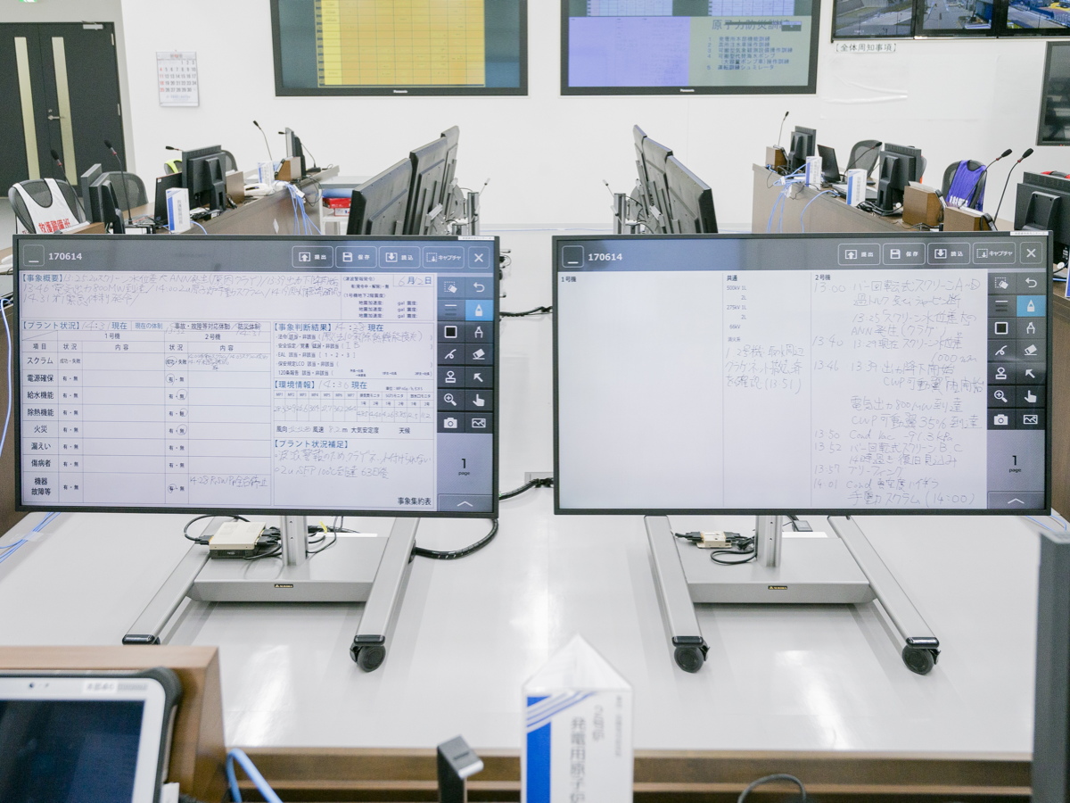 写真:2台の電子ホワイトボードの内容は、本部卓全員が見えるように8台のディスプレイに表示される